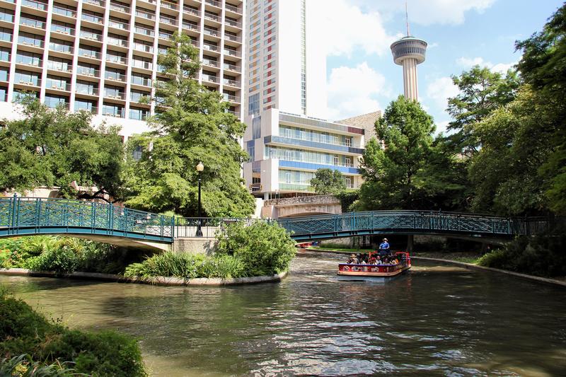 The San Antonio River Walk with the Tower of the Americas behind